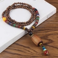 Ethnic style necklace with brown wooden beads, colorful accents and a large pendant - Plastic Coffee Cylinder