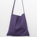 Detail of purple canvas tote bag showing white stitching and durable shoulder strap - Purple