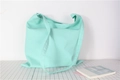 Detailed close-up of mint green canvas tote bag fabric and wide shoulder strap - Lake Green
