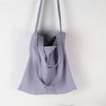Detailed view of light purple canvas tote bag hanging against a white wall for daily use - Light Purple