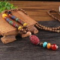 Ethnic wood bead necklace with colorful accents and red glass pendant for men and women - Glazed Red Flower