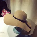 Women's wide brim straw sun hat in natural brown with a decorative black ribbon bow - M (56-58cm) / Large Flat Brim Style / Light Coffee