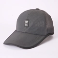 Detailed macro view of breathable mesh fabric and logo patch on dark gray sun cap - Dark Gray