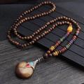 Ethnic wood bead necklace with colorful accents and a large patterned agate pendant - Water Drop