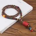 Ethnic style long necklace with dark wood beads and a large red cylinder pendant - Plastic Red Cylinder