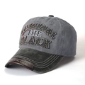 Close-up of vintage washed cotton baseball cap with embroidered text and leather trim - Black Brim + Grey
