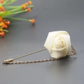 Elegant beige silk rose lapel pin with golden leaf detail and decorative hanging chain - Off-white