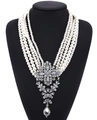 Macro shot of multi-layer faux pearl necklace with ornate crystal drop pendant on mannequin - Milky White/Clear