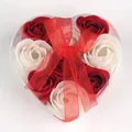 Heart-shaped gift box with red and white soap roses and a red decorative ribbon bow - Red + White