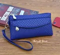 Detail of royal blue quilted faux leather clutch bag with gold zipper and wrist strap - Royal Blue