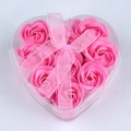 Detailed view of nine pink rose soap flowers in a clear heart-shaped gift box with a ribbon - Pink