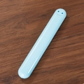 Sky blue capsule-shaped portable toothbrush travel case with hollow smiley design - Solid Blue