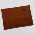 Solid caramel brown cashmere scarf with fringe edges, folded on a neutral background - Caramel color / 68x200cm