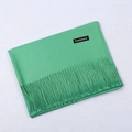Classic green cashmere scarf with fringe details folded neatly on a neutral background - Grass Green / 68x200cm