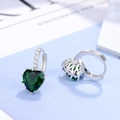 Close-up of S925 sterling silver heart-shaped green zircon earrings with small diamonds - Heart Hoop Earrings / White Gold - Green Zirconia