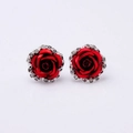 Close-up of red rose earrings with silver diamond-encrusted petals on white background - Red