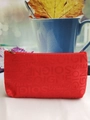 Detail view of a red fabric makeup bag with SOIGNE letter jacquard and zipper closure - Red