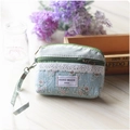 Detailed view of light blue floral cloth coin purse with lace trim and zipper closure - Green - Grid Coin Purse