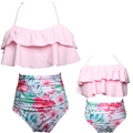 Detail of pink ruffle top and tropical floral print bikini bottoms for matching swimwear - Kids 116 / Top And Bottom / Pink Top Floral Bottom