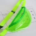 Macro detail of a neon green transparent PVC fanny pack showing zip and strap texture - Green