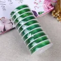 Macro shot of 10 spools of green elastic crystal cord for DIY jewelry making - 0.8mm / Fruit Green