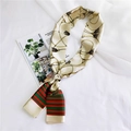 Detail shot of silk scarf with golden chain pattern and green red stripes on beige - Metal Chain Beige