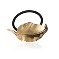 Elegant gold metal leaf hair tie with black elastic band on white background - Gold