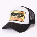 Detail of the distressed yellow embroidery patch on a black and white mesh trucker hat - Adjustable (54-62cm) / Black
