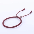 Close-up of handmade red braided cord bracelet with adjustable knot and woven texture - Dark Red