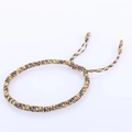 Detailed view of handmade braided knot bracelet with colorful adjustable cord strands - Multicolor