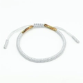 Macro shot of white handmade woven cord bracelet featuring adjustable sliding knot detail - Multicolor and Silver