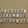 26 silver metal alphabet beads A-Z for DIY jewelry making displayed on brown paper - Letter A / Antique Silver