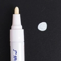 White permanent paint marker with fiber tip on black texture for photo album graffiti - White