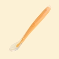 Orange silicone baby training spoon with clear outer layer and heart embossed handle - Orange