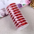Red elastic crystal bead string for DIY jewelry making on a textured background - 0.8mm / Red