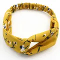 Elastic yellow floral headband with a twist knot and white daisy pattern detail - Turmeric Small Daisy