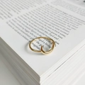 Elegant gold wavy open ring made of sterling silver displayed on an open book page - Crescent Ring (J-781)
