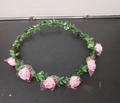 Pink foam rose floral headband with 6 roses and green leaves on a dark surface - Pink