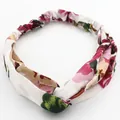 Elastic white headband with pink floral prints and a stylish front twist knot design - White Geranium