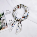 Silk-like white square scarf with zebra and heart patterns next to a lifestyle magazine - Pony Heart (23)