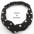 Classic black and white polka dot twist headband with a flexible elastic back strap - Black