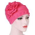 Close-up of rose red turban hat featuring side handmade flower and pink pearl beads - Rose Red