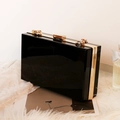 Elegant black acrylic evening clutch bag with golden metal frame and clasp closure - Black
