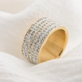 Macro close-up of a gold multi-row crystal ring on white fabric background - US 7 / Gold
