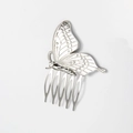 Detail of silver butterfly metal hair comb showing intricate wing patterns and five prongs - Silver