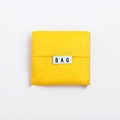 Foldable yellow square oxford fabric eco shopping bag with minimalist BAG logo tag - Yellow