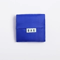 Foldable square navy blue Oxford fabric shopping bag in compact state with BAG label - Sapphire Blue