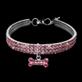 Detailed view of a pink rhinestone pet collar with a sparkling bone-shaped pendant - Pink / S