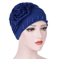 Detail of navy turban hat featuring handmade fabric flowers and delicate blue pearl accents - Sapphire Blue
