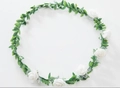 Floral headband featuring white foam roses and delicate lace on a green vine base - White